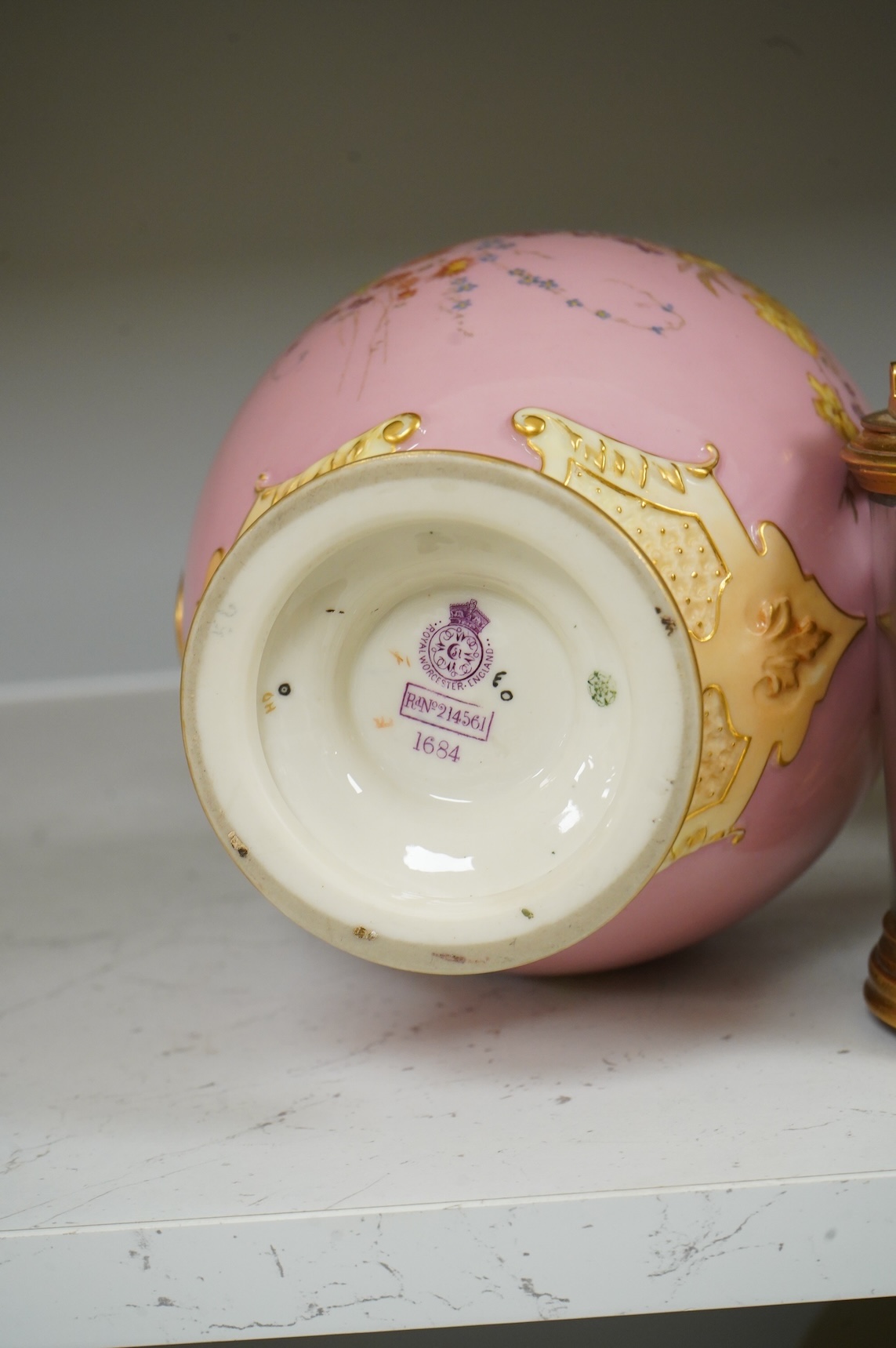 A Royal Worcester floral decorated two handled vase and cover, 30cm